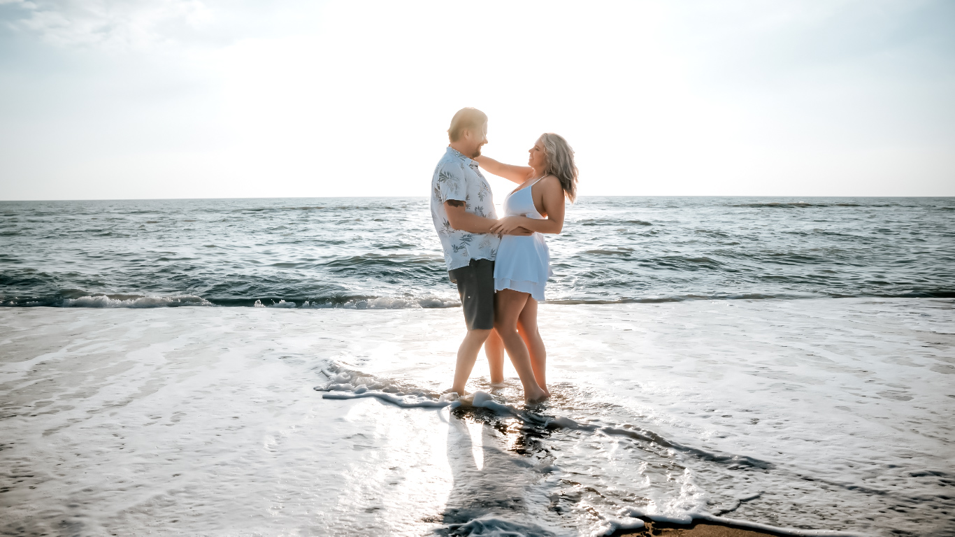 Romantic couple on the beach during sunset, showcasing the beauty of vacation photography secrets.